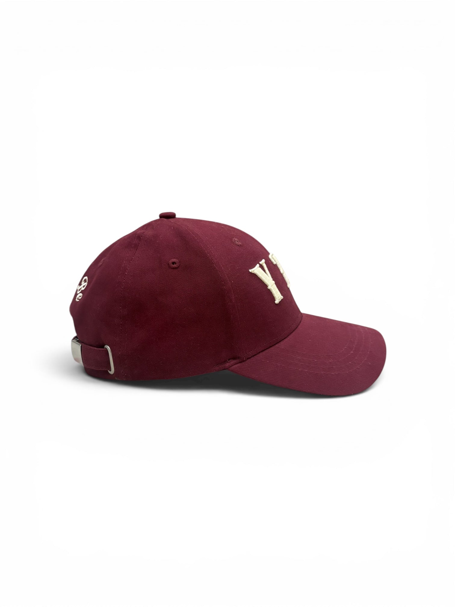 Maroon Yet To Be baseball cap, side view, showing embroidered logo and adjustable strap