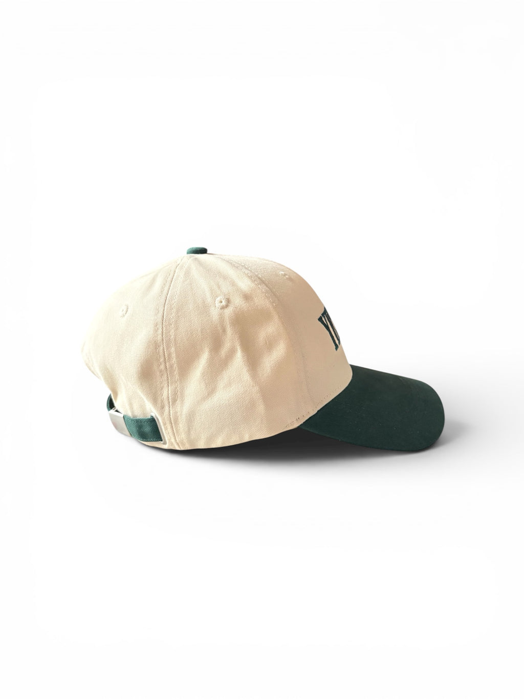 Cream and green Yet To Be baseball cap, back three-quarter view, showing adjustable strap
