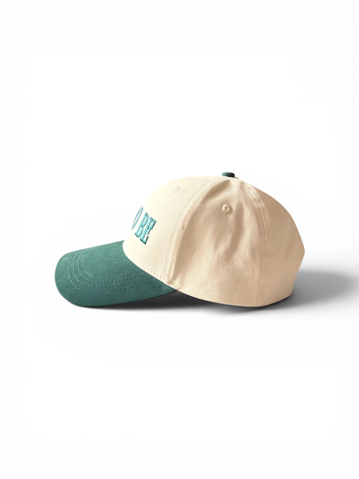 Cream and green Yet To Be baseball cap, side view